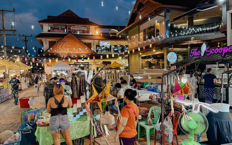 Vista panorâmica do mercado noturno de Chiang Rai com luzes brilhantes e lotado de turistas