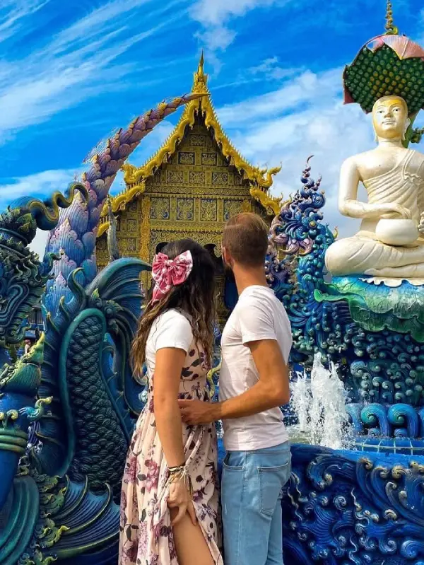 Couple admires Blue Temple’s sacred fountain art