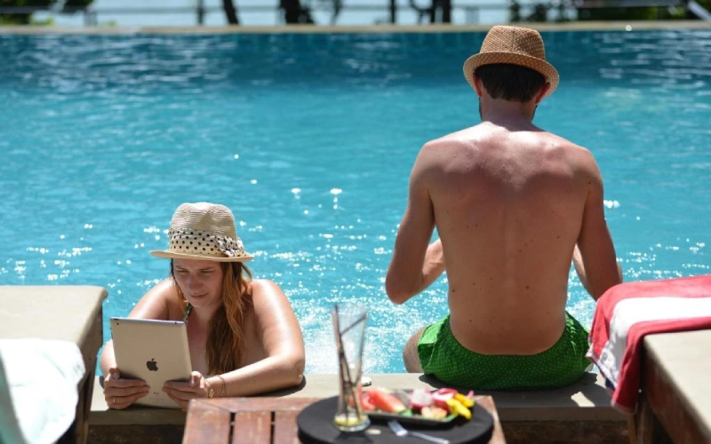 Casais relaxam juntos na piscina turquesa ampla