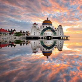 Sunrise reflections on the Straits Mosque in Malacca